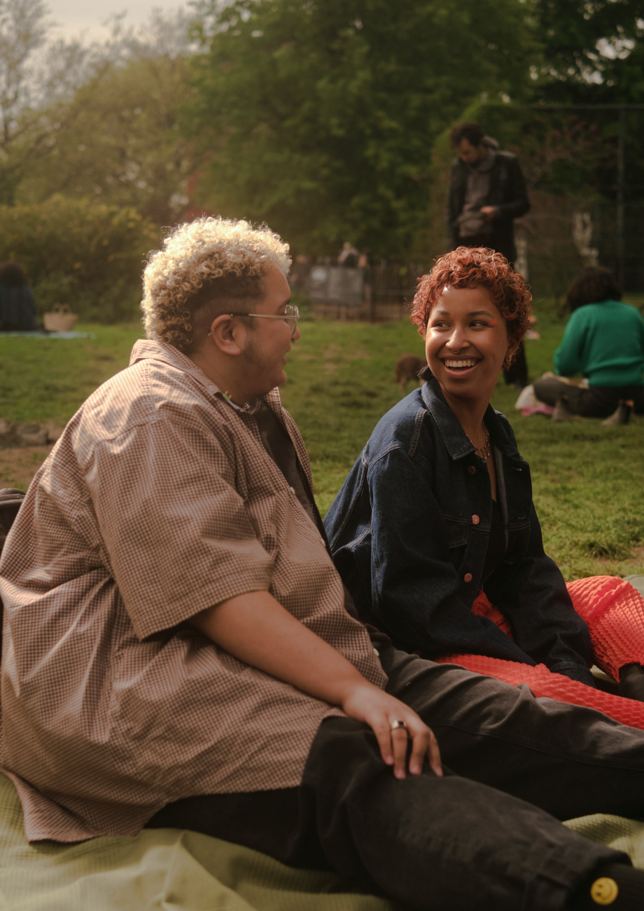 nonbinary trans man standing outside with a bicycle