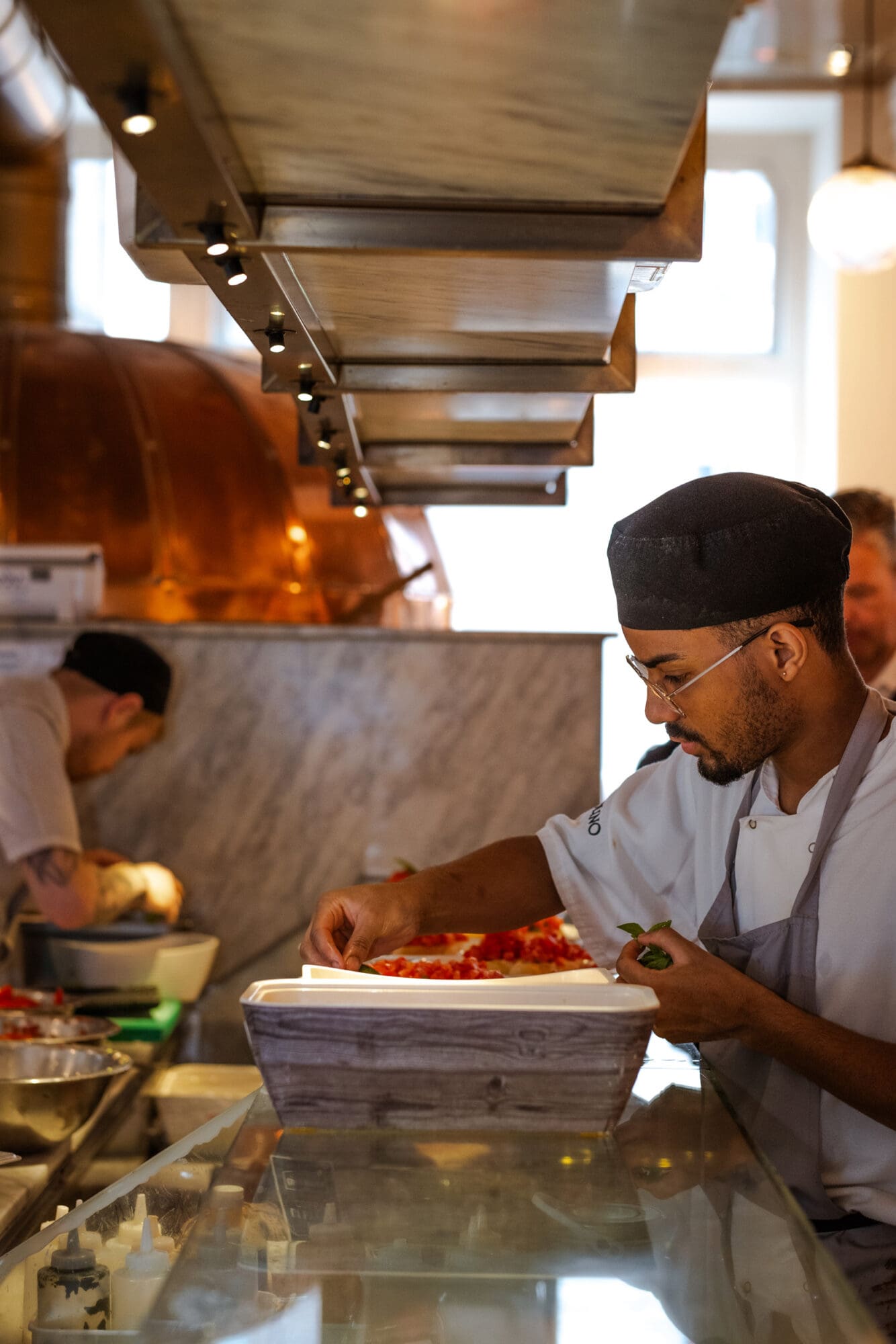 Cooks are cooking food in a restaurant kitchen