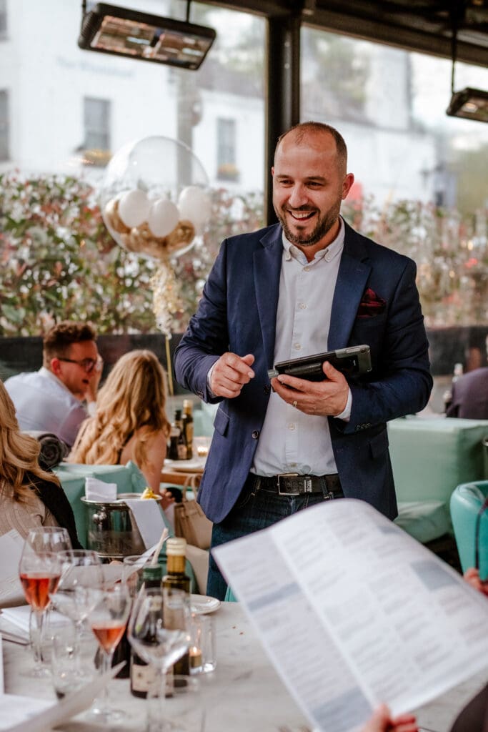 Happy man standing next to a table