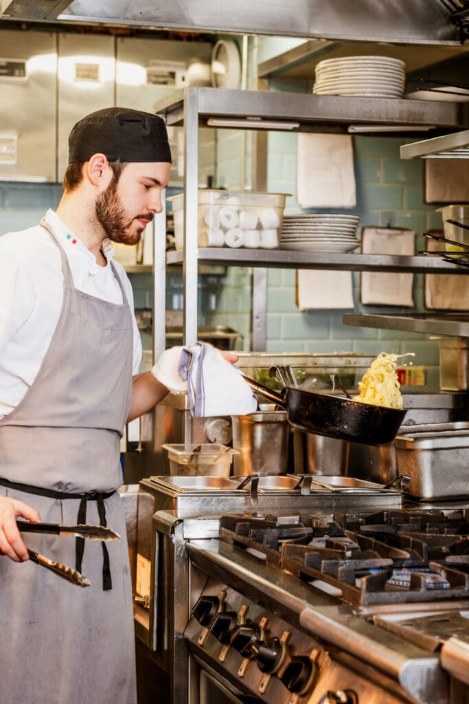 Chef is cooking pasta dish